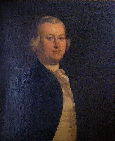 Color photograph of a painting of a middle-aged white man wearing a white wig, dark jacket, yellow vest and white cravat. The painting is very dark and no background can be seen. 